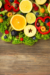 Beautiful bouquet of fruits and vegetables on wooden background, close up