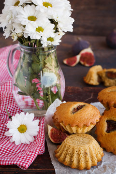 Muffins with figs.Jug of flowers.