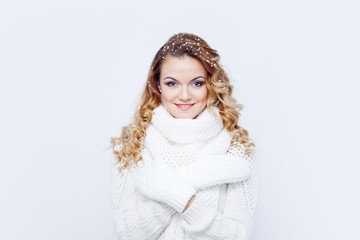 Woman  in  warm knitted scarf and gloves, portrait on  white background, place for your text