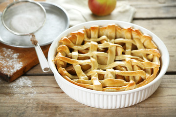 Homemade apple pie on wooden background