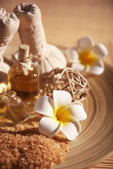 Natural relaxing spa set in a bowl with sea salt on wicker background