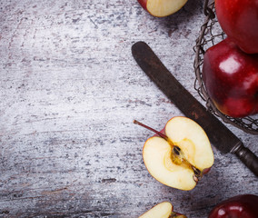 Fresh red apples in a metal basket on wooden background.Copy space.selective focus.