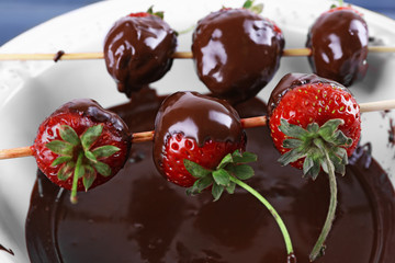 Delicious strawberries in chocolate in a bowl close-up