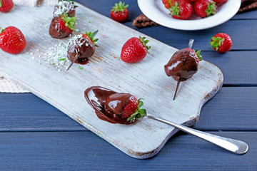 Delicious strawberries in chocolate on kitchen table