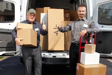 Group of delivery men near shipping truck.