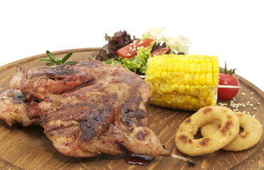 preparation of quail on the grill in the restaurant on a wooden plate