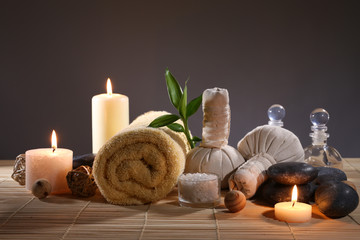 Beautiful spa set on wicker napkin on dark background