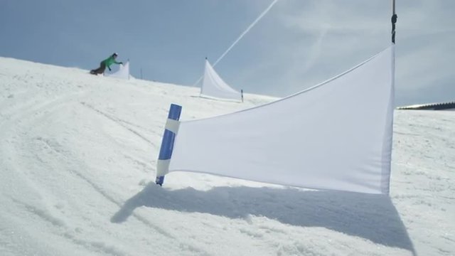 SLOW MOTION: Professional race snowboarder riding slalom