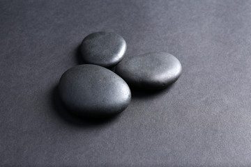 Fototapeta na wymiar Group of pebbles on dark background