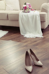 Fototapeta na wymiar Wedding bouquet, bridesmaid dress and shoes in room