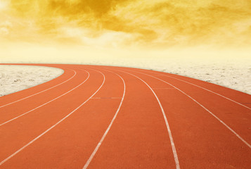 outdoor running track with desert at sunset