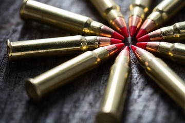 Macro shot of small-caliber tracer rounds with a red tip