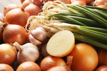 Fresh different onions and garlic background