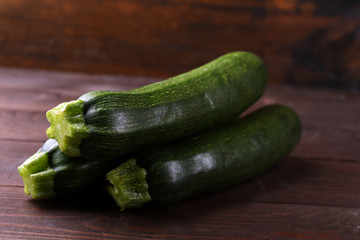 Fresh zucchini on wooden background