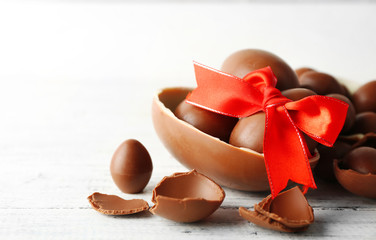 Chocolate Easter eggs on white wooden background
