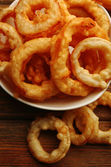 Chips rings in bowl on wooden background