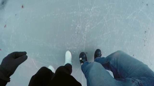 FIRST PERSON VIEW: Couple ice skating on frozen lake