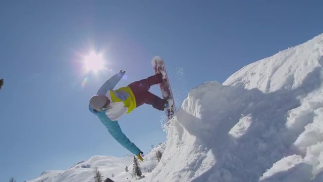 SLOW MOTION: Snowboarder does handplant trick