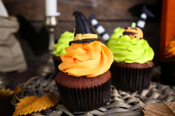Halloween cupcakes on wicker mat on table