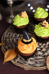 Halloween cupcakes on wicker mat on table