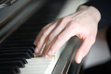 Fototapeta na wymiar Close up of man hands piano playing