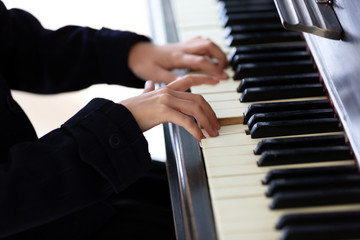 Close up of little girl hands piano playing