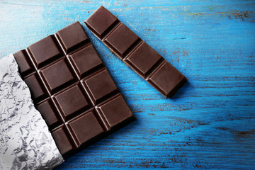 Dark Chocolate bar in foil  on gray background