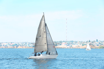 Sailing yacht on river