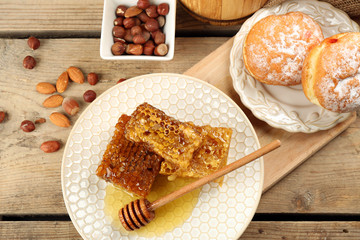 Honeycombs on plate on wooden background