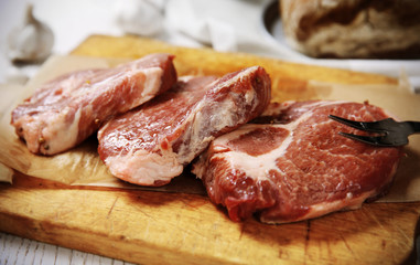 Marbled beef steak and spices on wooden background