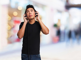 young chinese man listening to music