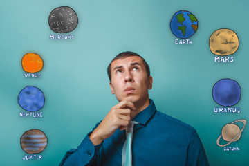 businessman man holds his chin thinking planets of the solar sys