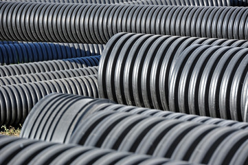 Stacked new PVC pipe on construction site