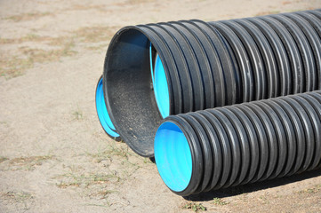 Stacked new PVC pipe on construction site