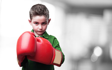 little kid fighting with red boxing gloves