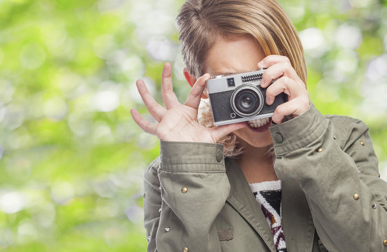 beautiful young woman taking photos with her camera