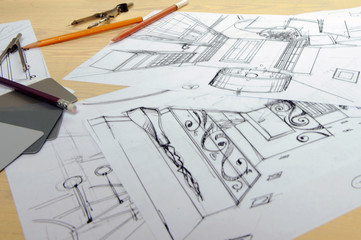 Drawings, sketches, pencils, stationery on the table.