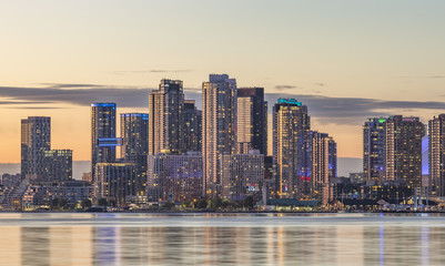  Toronto Harbourfront  district skyline with   the adjacent high-rise condo buildings - illuminated during sunset . - obrazy, fototapety, plakaty
