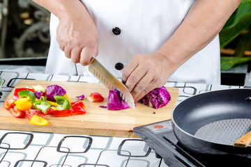 Chef cutting tomato