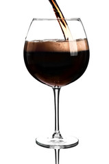 Dark beer pouring into glass on white background