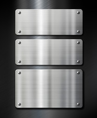 stainless steel metal plates on black brushed background