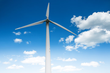 Wind energy turbine and fluffy clouds in the sky