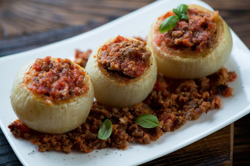 Closeup of onions stuffed with ground beef meat and then baked