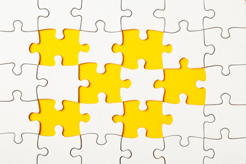 Missing puzzle pieces on yellow background