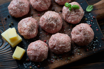 Close-up of uncooked meatballs with seasonings, high angle view