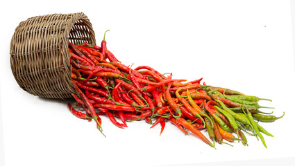 Colorful chillies with the basket on white background