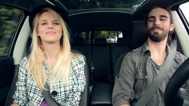  cool happy hipster couple singing in car