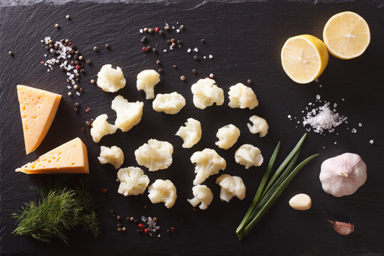 Cauliflower with ingredients on a stone table. horizontal top view 
