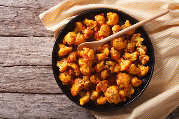cauliflower with tomatoes in curry. Horizontal top view
