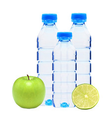 Blue bottles with water, lime and green apple isolated on white